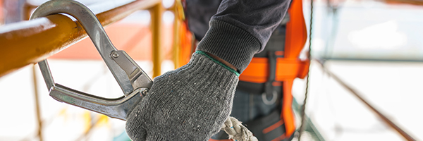 Construction worker attached to harness