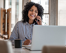 Woman on phone and laptop