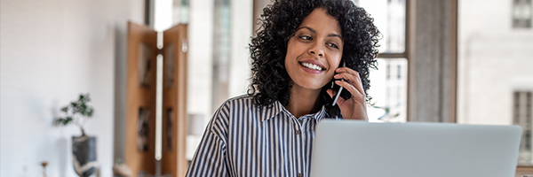 Woman on phone and laptop