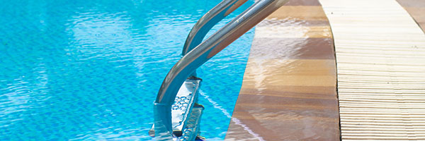 Ladder leading into inground pool