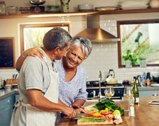 woman and man chopping vegetables in kitchen