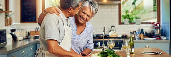 woman and man chopping vegetables in kitchen