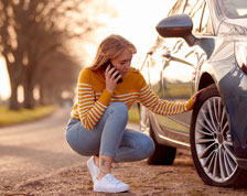 woman looking at flat tire