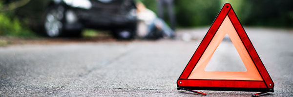 caution sign in front of car accident