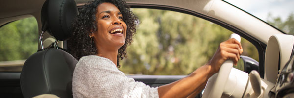 woman happily driving car