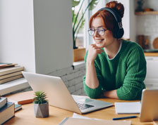 woman happily working on her laptop