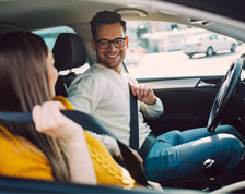 man and woman getting into car