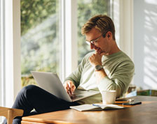 man working on laptop at table
