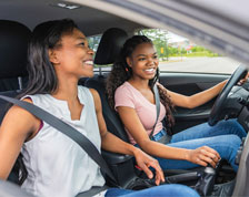 teenager learning to drive with an adult