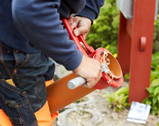 worker pulling pipe from underground