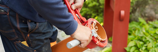 worker pulling pipe from underground